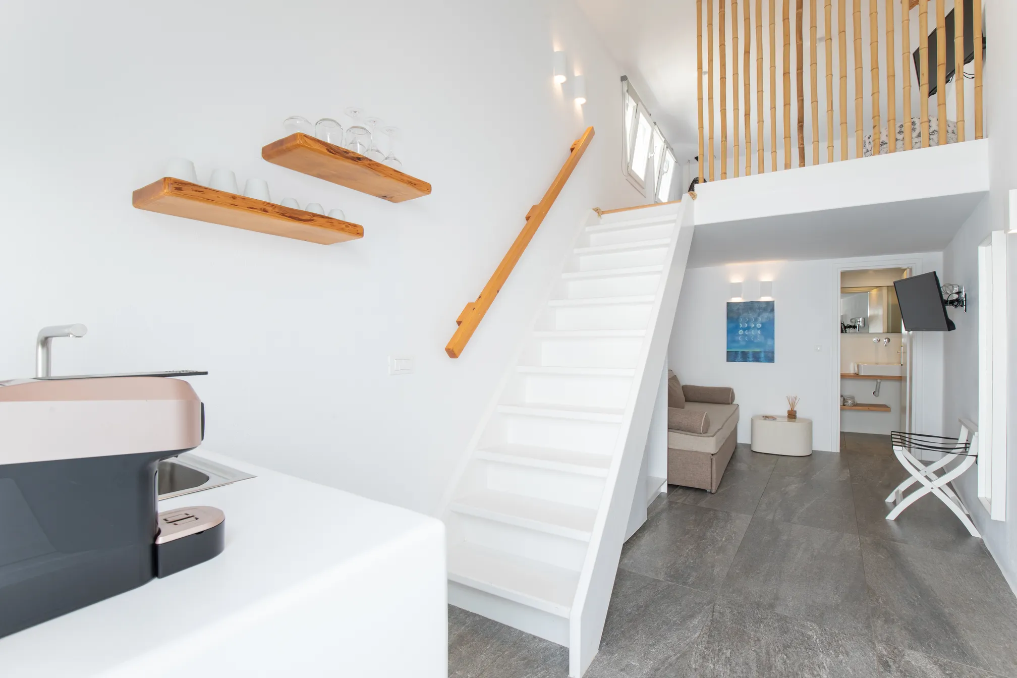 Kitchenette with espresso machine below the stairs